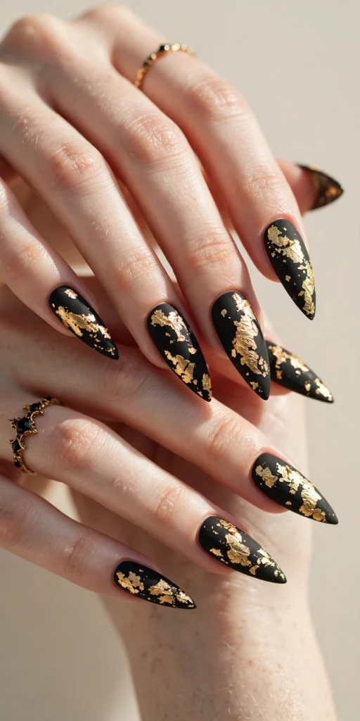 Matte black Halloween nails with gold foil flakes